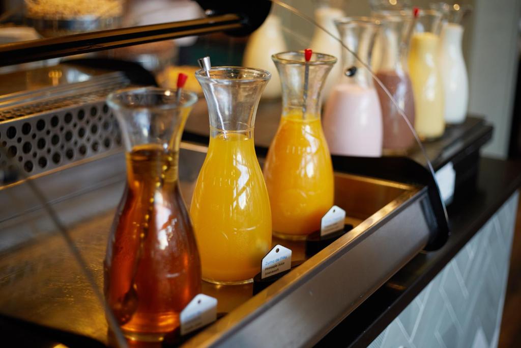 a row of juice bottles sitting on a counter at Secrets Lanzarote Resort & Spa - Adults Only (+18) in Puerto Calero