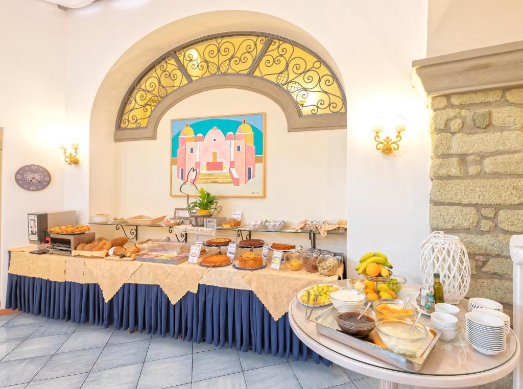 a table with a bunch of food on it at Hotel Nettuno in Ischia