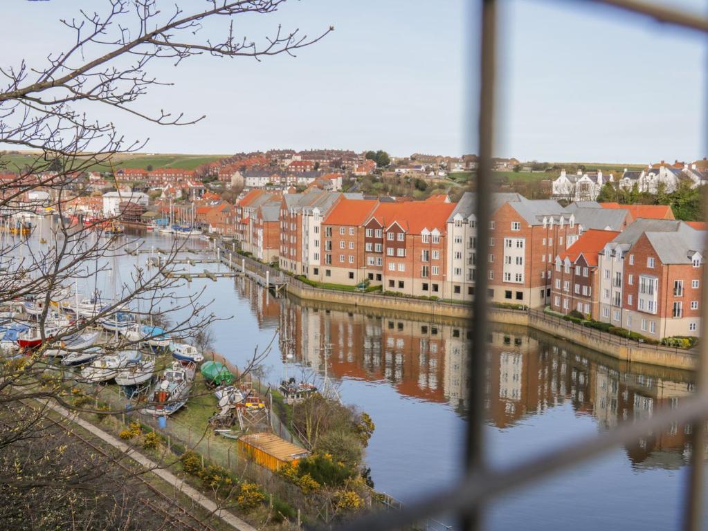 a view of a city with boats in the water at Whitby Harbour Retreat in Whitby