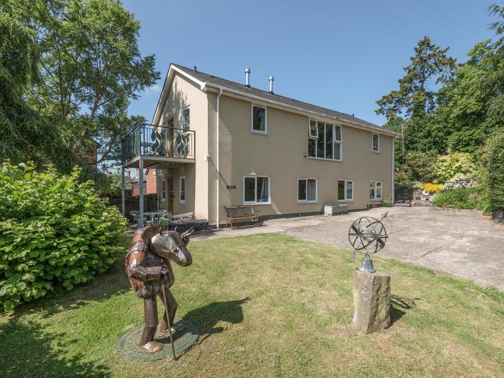 a statue of a horse in front of a house at The Schoolhouse Bakehouse in Bishops Castle