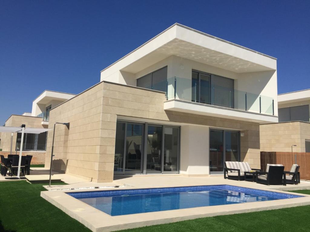 a house with a swimming pool in front of it at 3018 Vistabella- Malibu in Orihuela