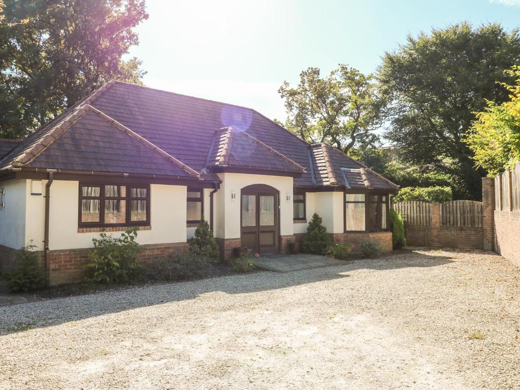 a white house with a black roof and a driveway at Induja in Dore