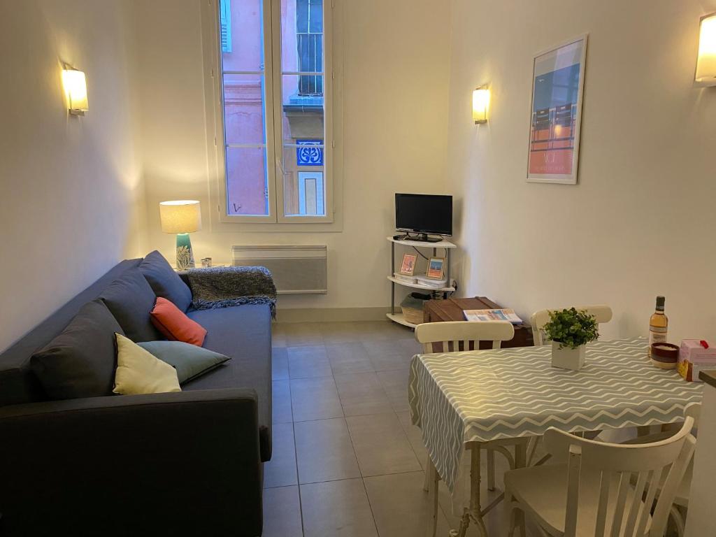 a living room with a couch and a table at In the heart of Old Nice - 2min. from Cours Saleya and Promenade des Anglais in Nice
