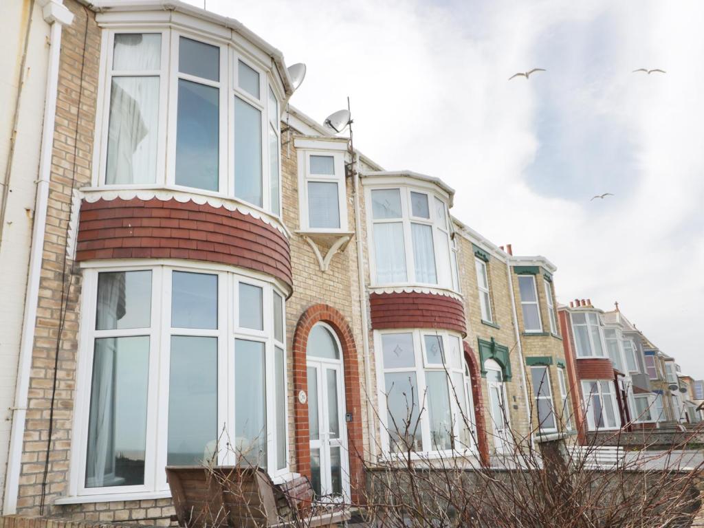 a large brick building with white windows on it at Number Fifteen in Withernsea