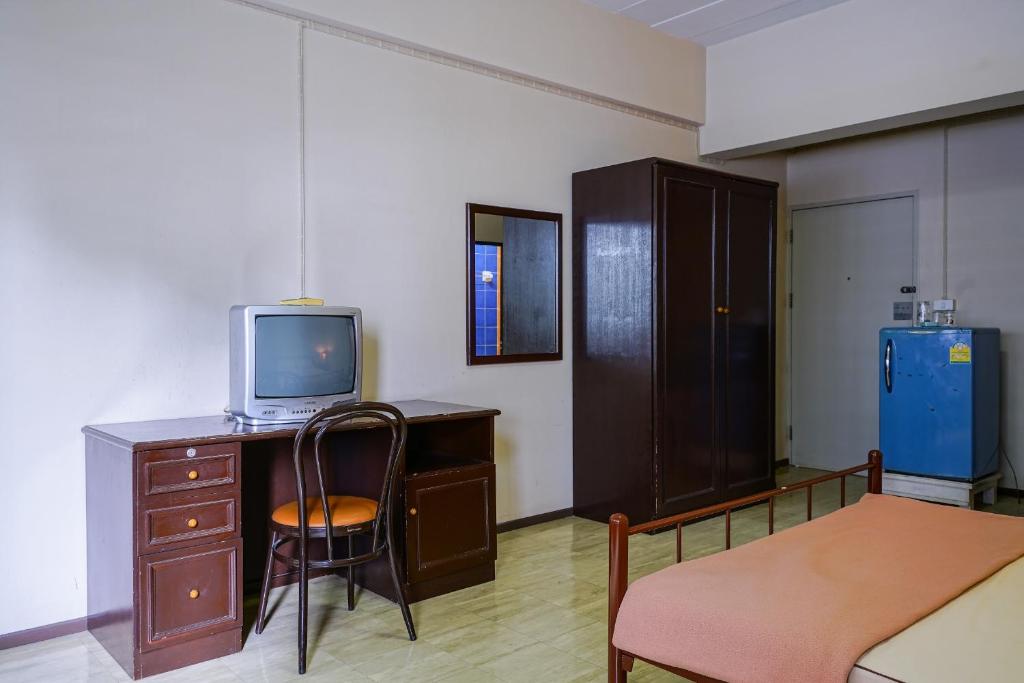 Camera con scrivania, TV e sedia. di Vintage Studio Apartment Thonglor Ekkamai a Ban Na Song