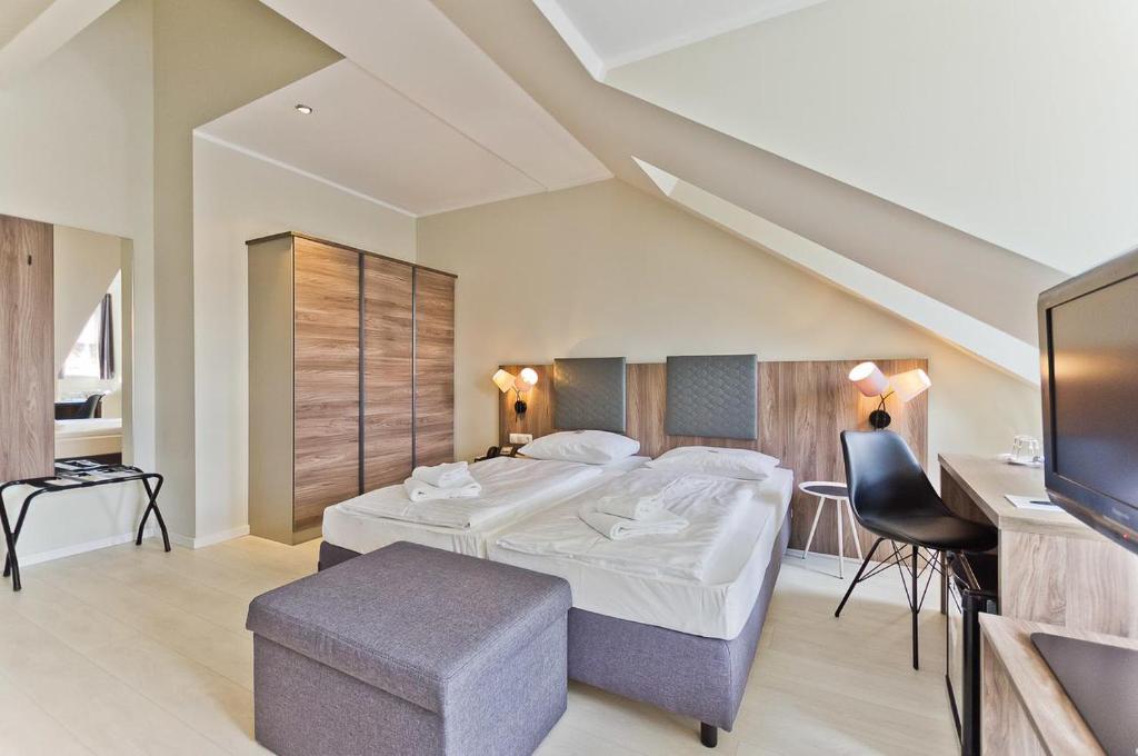 Postel nebo postele na pokoji v ubytování Hotel Astor