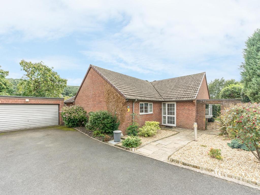 a brick house with a garage at Sunny Corner in Church Stretton