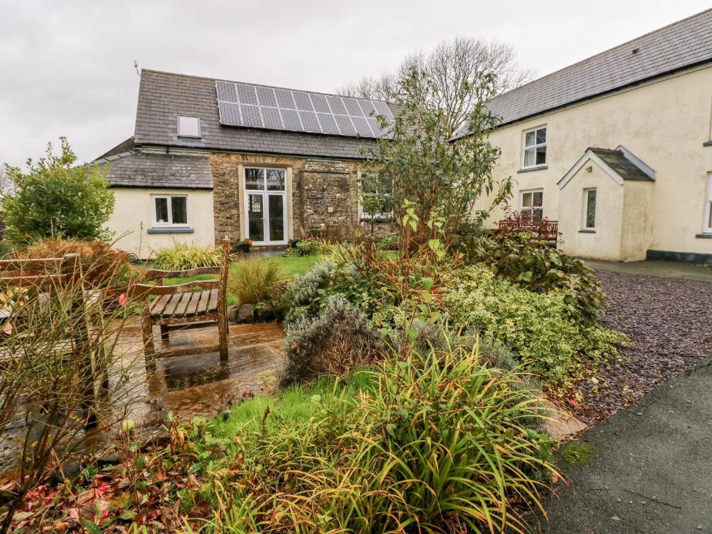 a house with solar panels on the roof at School House in Haverfordwest