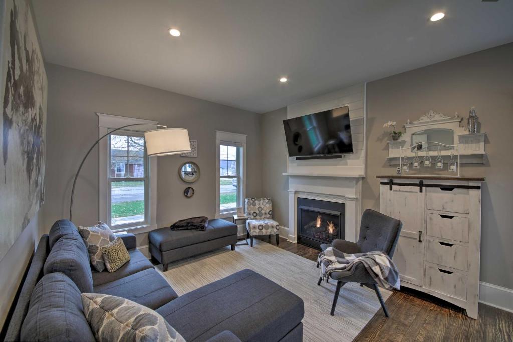 a living room with a couch and a fireplace at Renovated Craftsman House with Patio and Fire Pit! in Vevay
