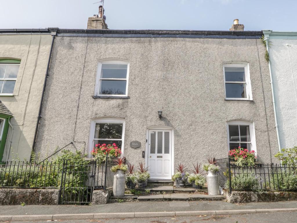 a brick house with flowers in front of it at Hillside in Broughton in Furness