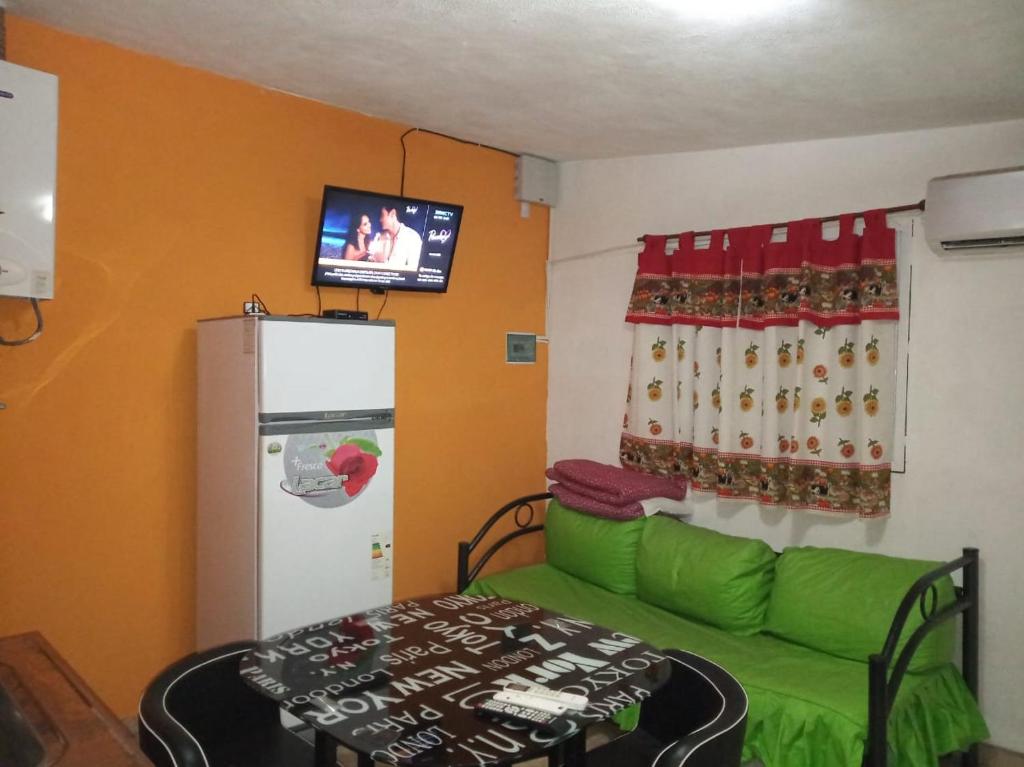 a living room with a green couch and a refrigerator at Casas Cordoba in Villa Parque Siquiman