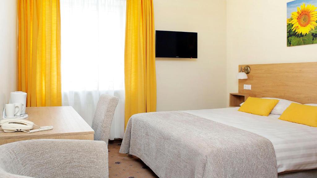 Postel nebo postele na pokoji v ubytování Hestia Hotel Draugi