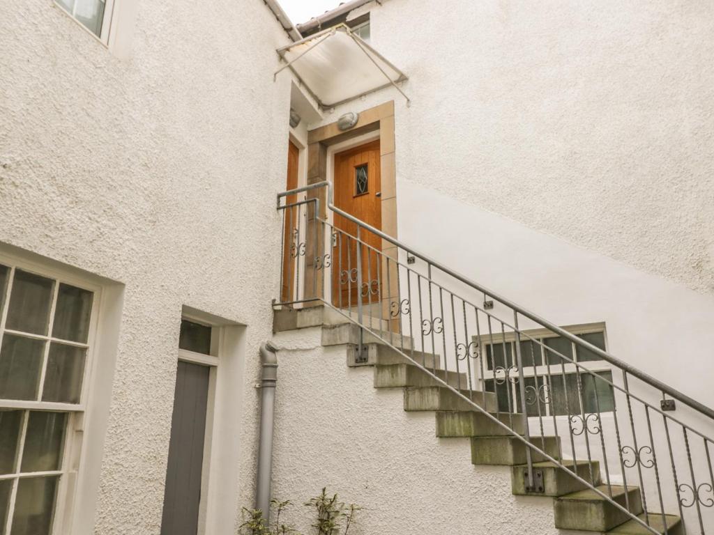 a staircase leading to a door in a building at Hayloft in Pittenweem