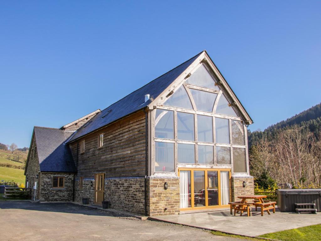 a barn conversion with large windows and a picnic table at The Hayloft in Knighton