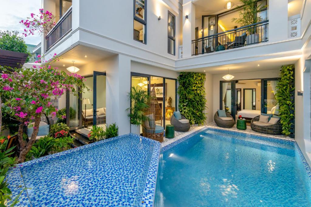 a swimming pool in the middle of a house at Volar de Faifo Villa in Hoi An