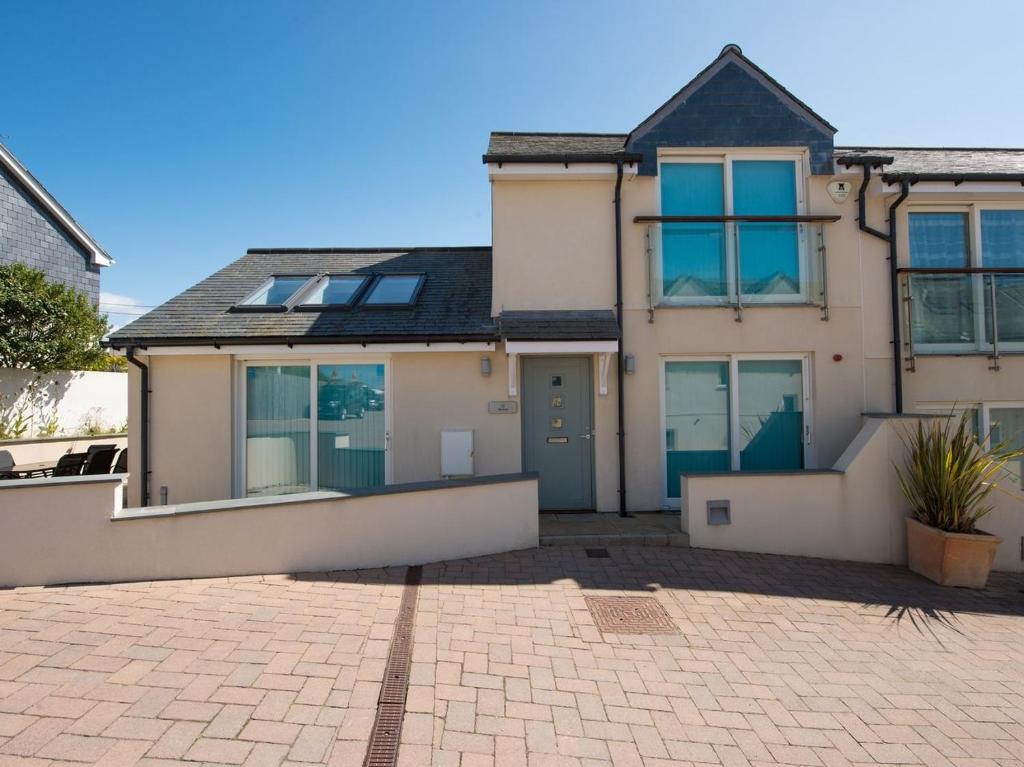 a house with a brick driveway in front of it at Neptune in St Merryn