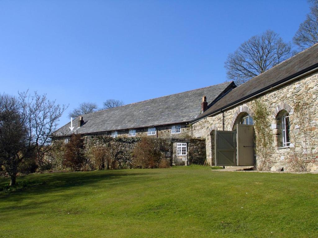 a stone building with a large yard in front of it at Harry in Bodmin