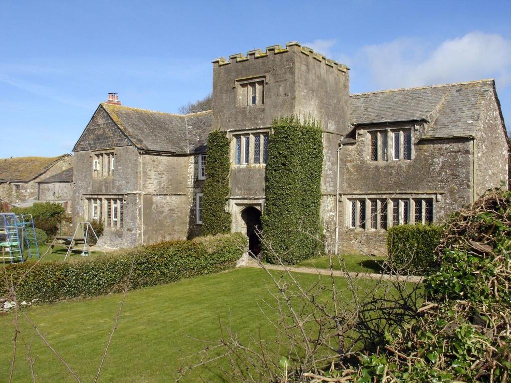 um velho castelo com hera crescendo ao lado dele em Tresungers Cottage em Port Isaac