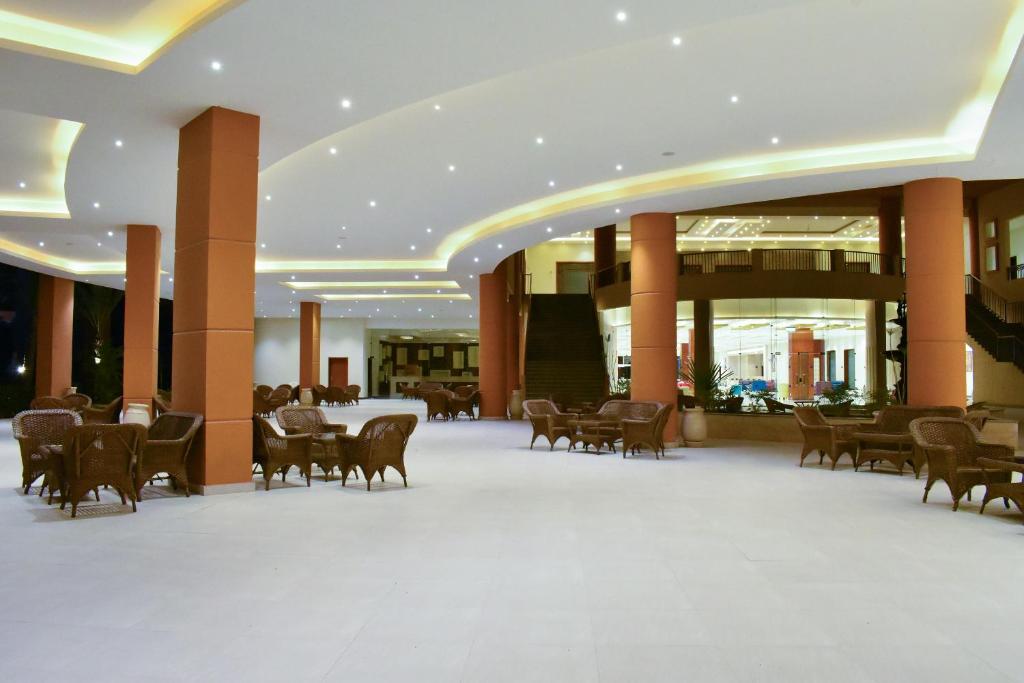 a lobby with a table and chairs in a building at Parrotel Lagoon Waterpark Resort in Sharm El Sheikh