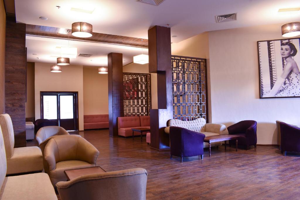 a waiting room with couches and tables and chairs at Parrotel Lagoon Waterpark Resort in Sharm El Sheikh