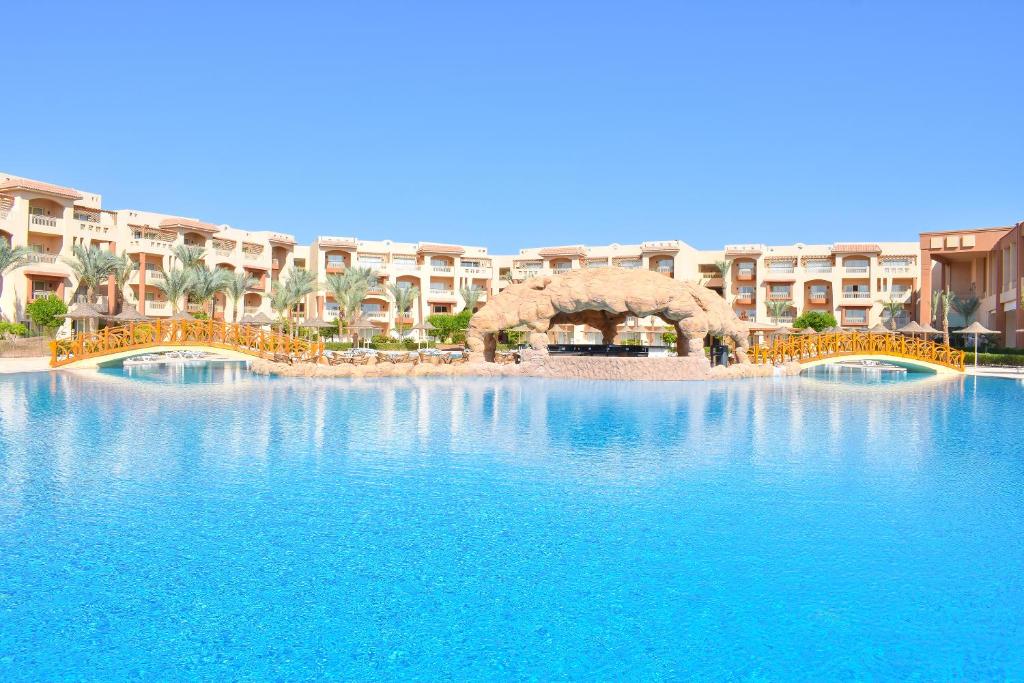 a large swimming pool in front of a resort at Parrotel Lagoon Waterpark Resort in Sharm El Sheikh