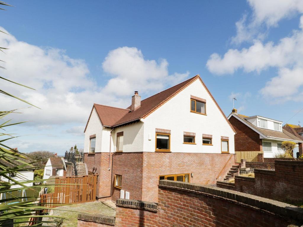 a house on top of a brick wall at Gweld y Môr in Colwyn Bay