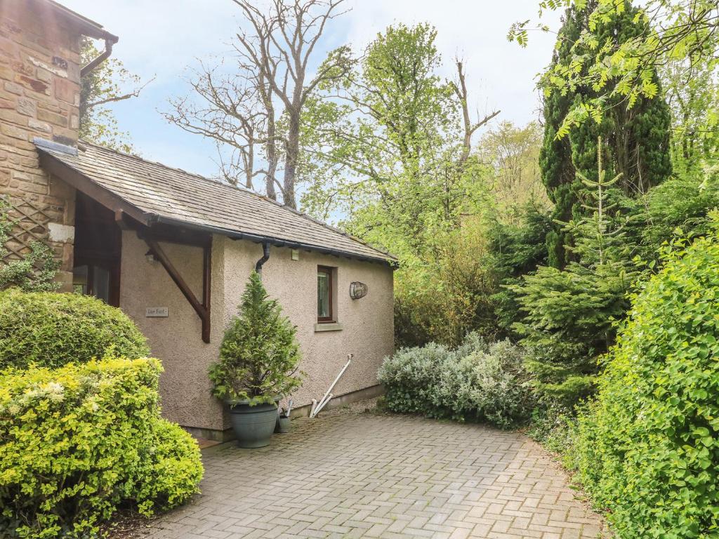 a house with a brick driveway in front of it at Doe Foot Cottage in Ingleton 