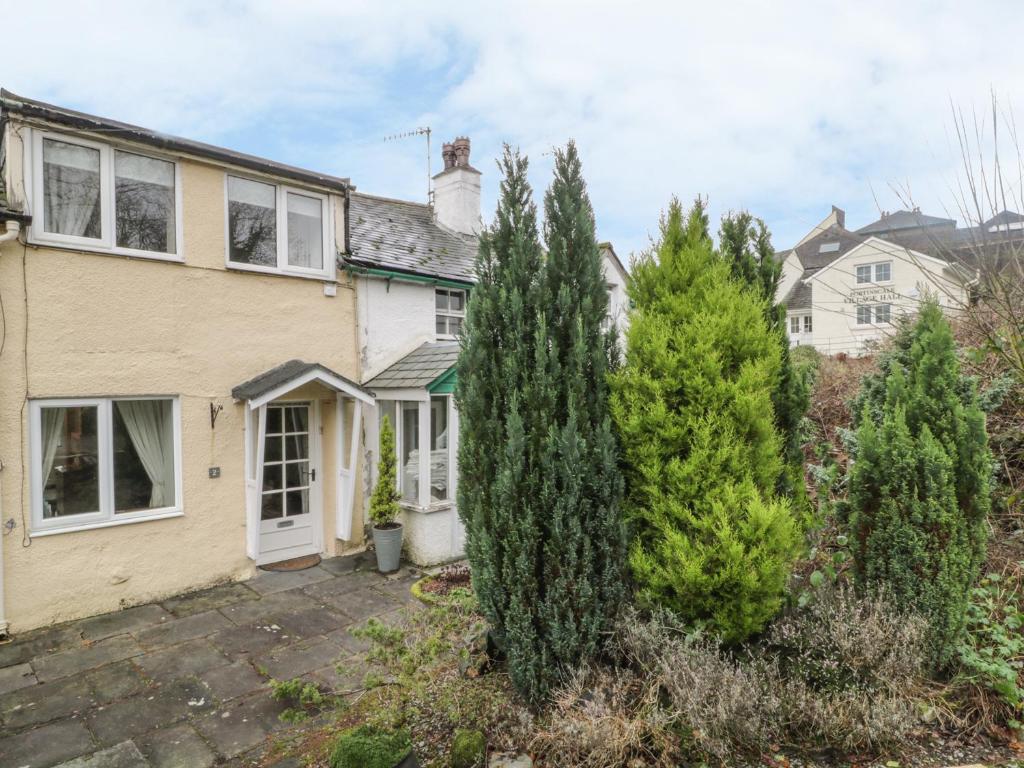 a house with trees in front of it at Derwent Edge in Portinscale