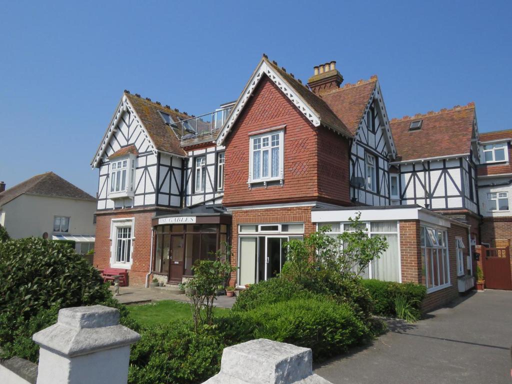 a large brown and white house with a driveway at Swanage Bay Apartment in Swanage