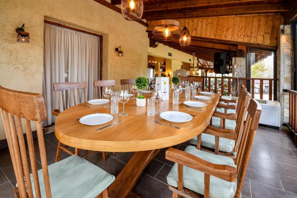 a dining room with a wooden table and chairs at Archontiko Liamas in Stavros