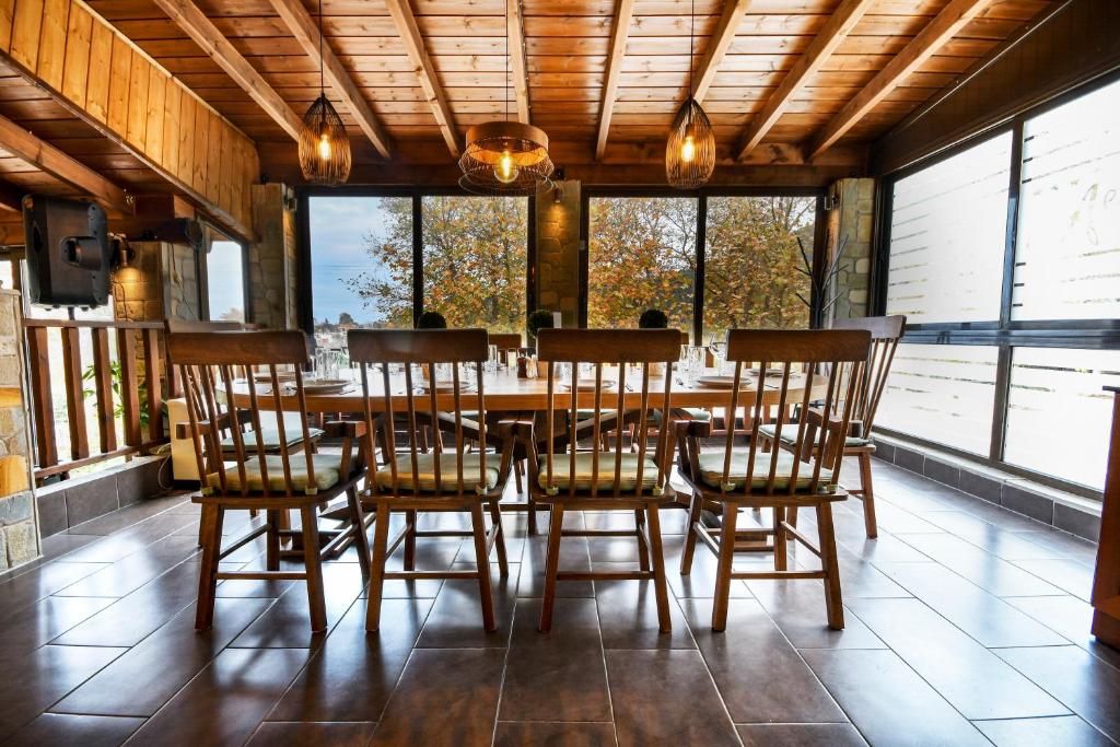 a dining room with a wooden table and chairs at Archontiko Liamas in Stavros