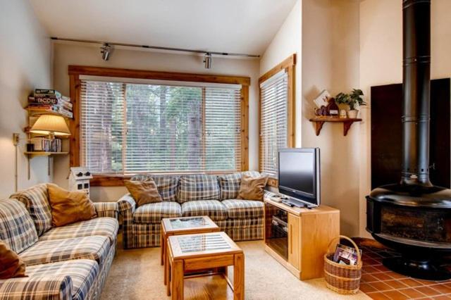 a living room with two couches and a fireplace at Ski-In and Ski-Out Northstar Condo near Lake Tahoe! in Truckee