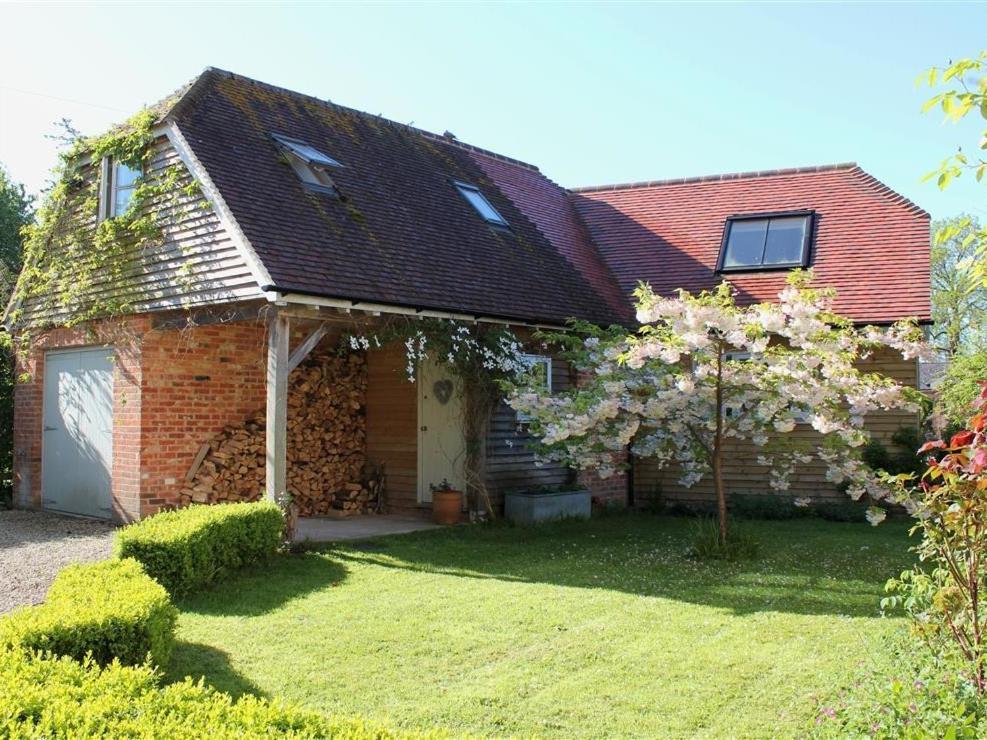 a brick house with a tree in the yard at Bridge Studio in Broad Chalke