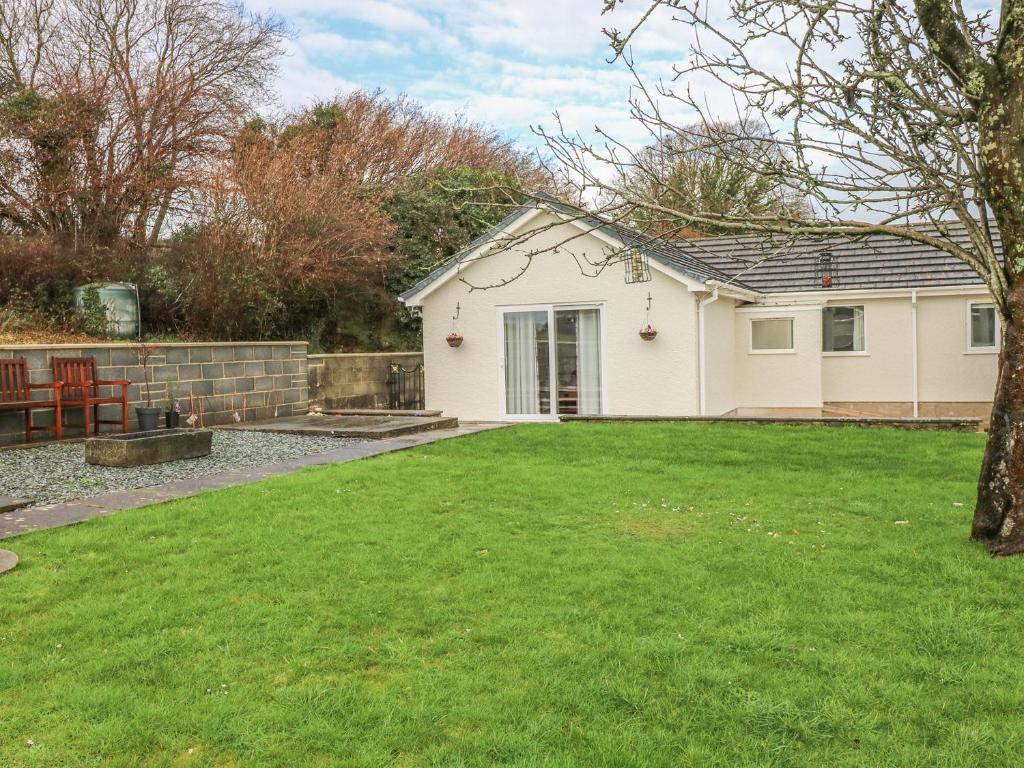 a house with a lawn in front of it at Broadford Farm Bungalow in Kidwelly
