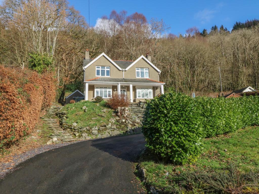 a house on a hill with a driveway at Coedfryn in Betws-y-coed
