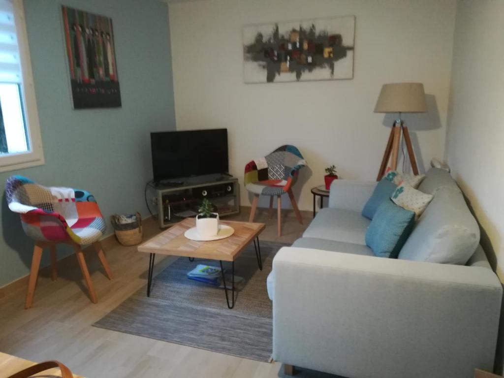 a living room with a couch and a table at maison de vacances baie du Mont Saint Michel in Dol-de-Bretagne