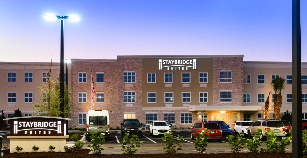 a large building with cars parked in a parking lot at Staybridge Suites - Vero Beach, an IHG Hotel in Vero Beach