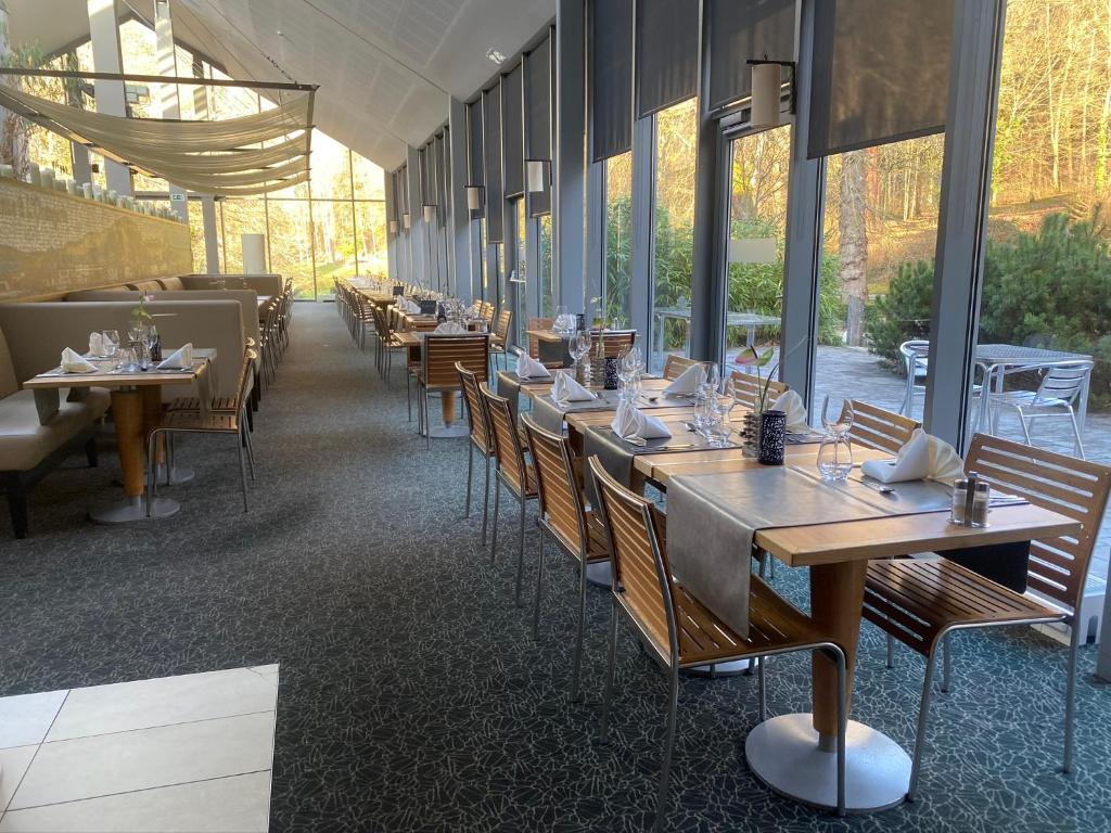 a row of tables and chairs in a restaurant at Castel de Pont-a-Lesse in Dinant