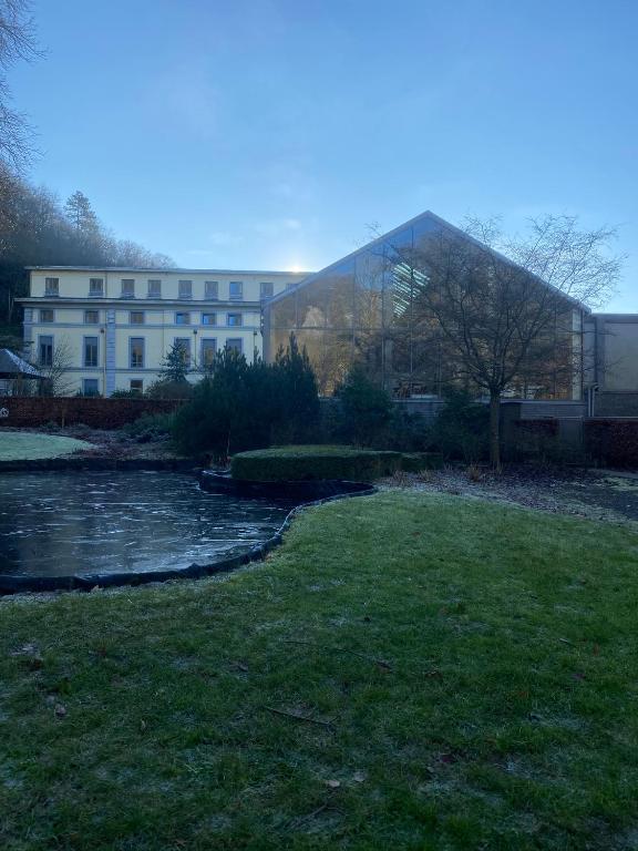 a building next to a river next to a building at Castel de Pont-a-Lesse in Dinant