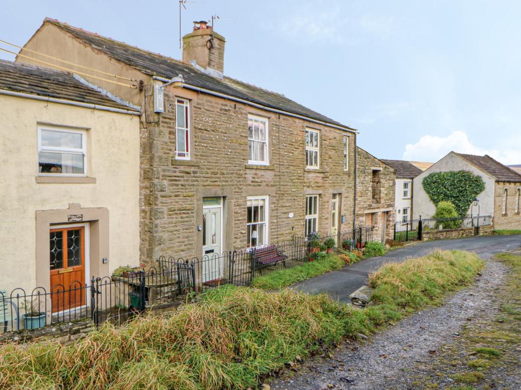 a row of brick houses on a street at Primrose Cottage in Hawes