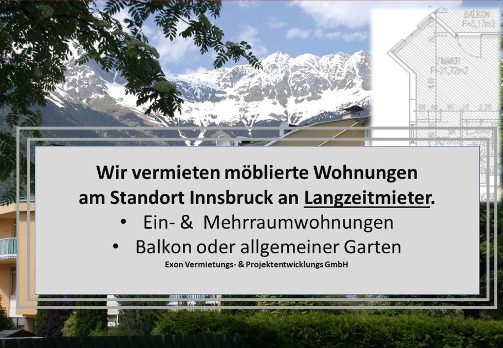Wohnen in Innsbruck في إنسبروك: علامة أمام جبل مغطى بالثلج