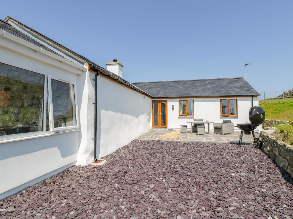 a detached house with a patio in front of it at Pen Y Braich Uchaf in Brynkir