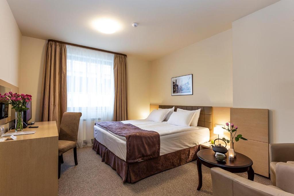 a hotel room with a bed and a desk at Sofia Palace Hotel by HMG in Sofia