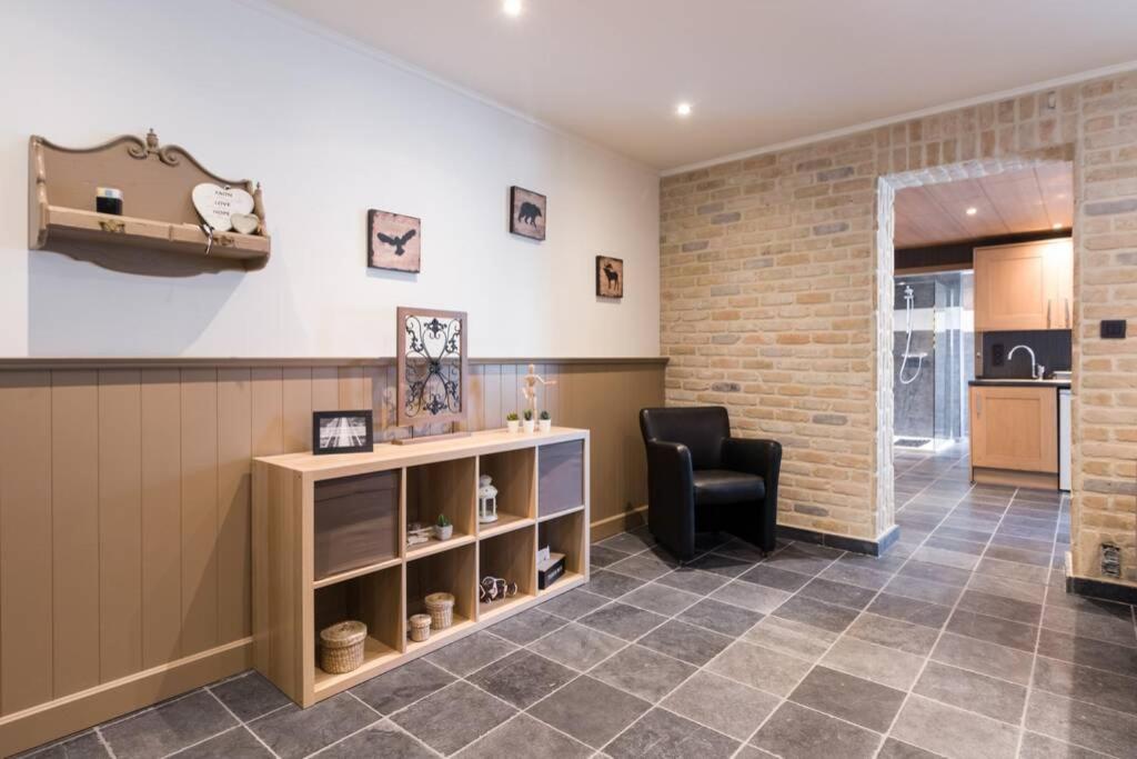 a waiting room with a chair and a table at Spacious Appartment aan damse vaart @ brugge in Bruges