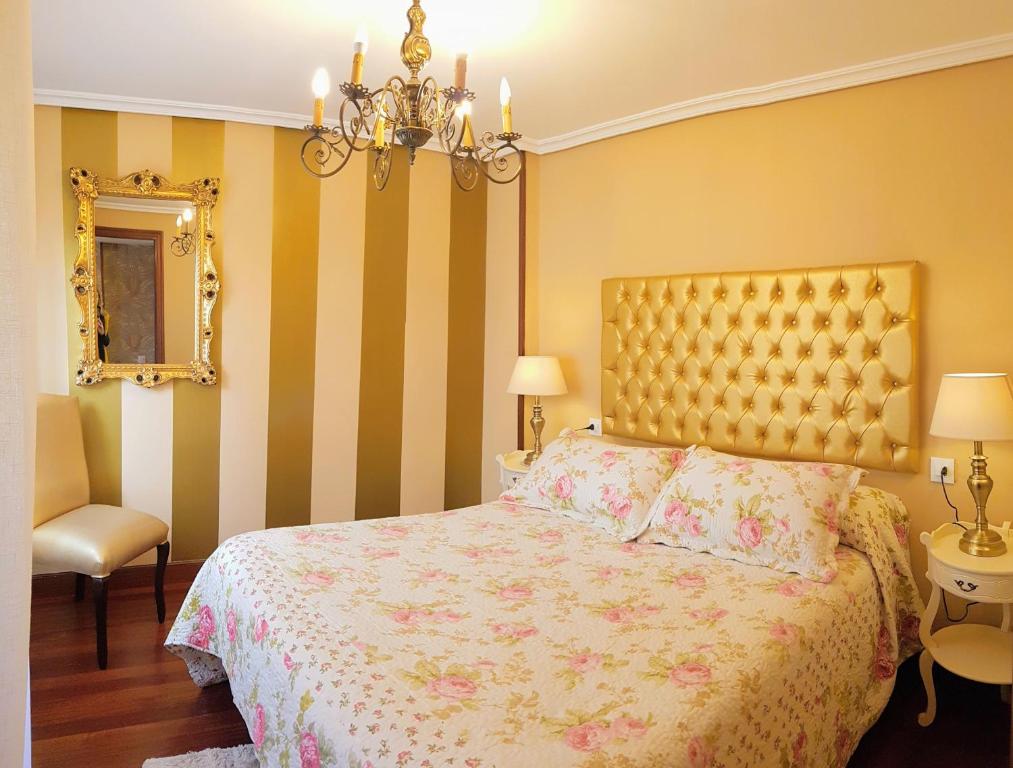 1 dormitorio con cama y lámpara de araña en La Casa de Begoña, en Laguardia