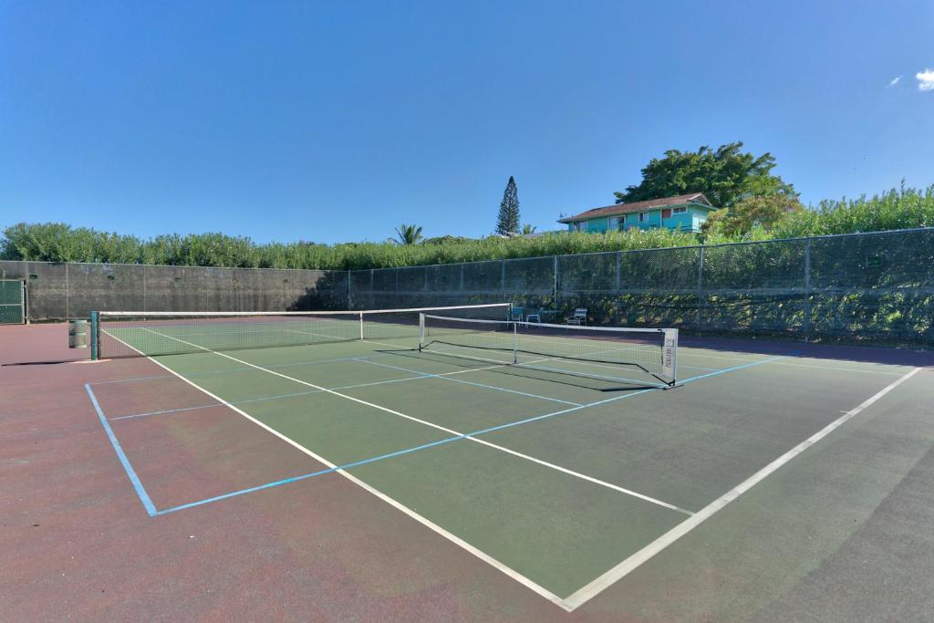 a tennis court with two tennis rackets on it at Maui Kamaole in Wailea