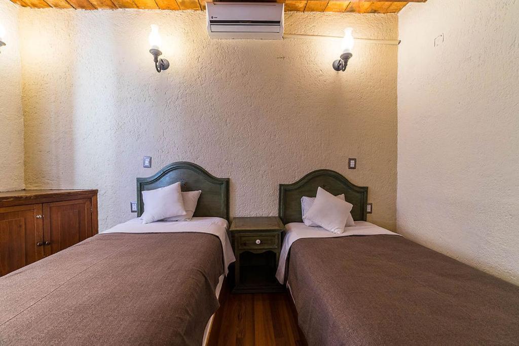 Postel nebo postele na pokoji v ubytování Mesón de la Merced Hotel Boutique Patio & Spa
