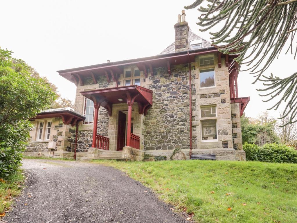 an old stone house on a road at East Firwood in Rothesay