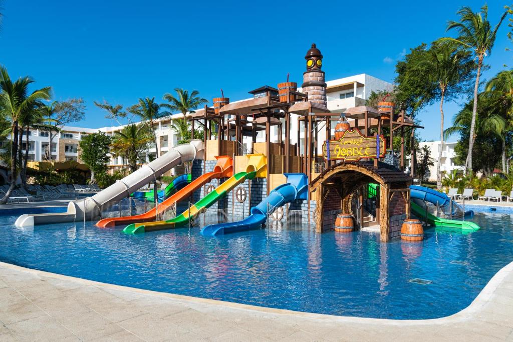 a water slide in a swimming pool at a resort at Princess Family Club Bavaro - All Inclusive in Punta Cana