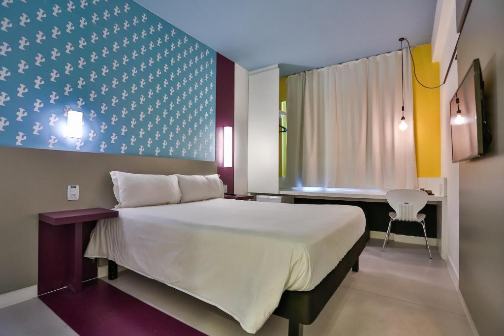 Cama ou camas em um quarto em Nobile Inn Pampulha